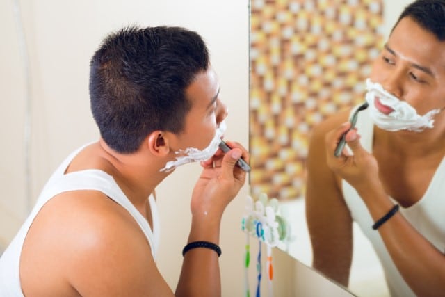 Man Shaving in Bathroom